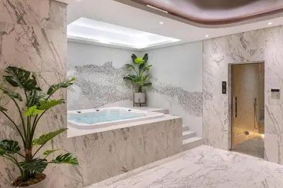 a bathroom with a tub with a potted plant in it at StoneTree - Furnished 2BR with Luxurious Style in Dubai