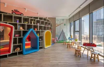a childrens room with a play area with a play set at StoneTree - Furnished 2BR with Luxurious Style in Dubai
