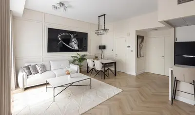 a living room with a couch and a table at Beautiful stylish 1 bedroom by the JBR beach ! in Dubai