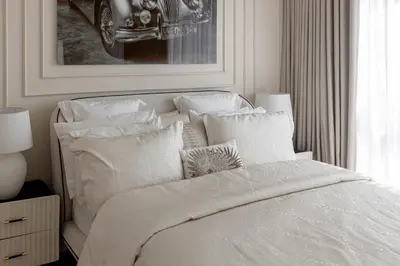 a bedroom with a white bed with white pillows at Beautiful stylish 1 bedroom by the JBR beach ! in Dubai