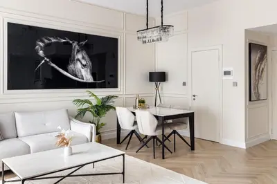 a living room with a table and a horse picture on the wall at Beautiful stylish 1 bedroom by the JBR beach ! in Dubai