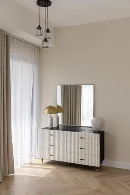 a living room with a dresser with a mirror at Beautiful stylish 1 bedroom by the JBR beach ! in Dubai
