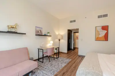 a living room with a couch and a table at BEAUTIFUL HUGE 2 BED ROOM APARTMENT in Dubai