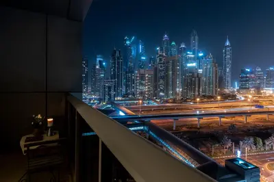 a view of a city skyline at night at BEAUTIFUL HUGE 2 BED ROOM APARTMENT in Dubai