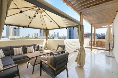 a living room with a couch and a table at Plaza Residences - 2BR Apartment - Allsopp&Allsopp in Dubai