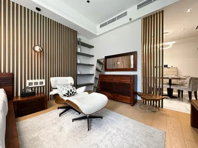 a bedroom with a white chair and a desk at Trophy - Private Office Solace Suite in Dubai