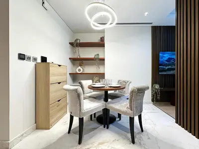 a dining room with a table and chairs at Trophy - Private Office Solace Suite in Dubai