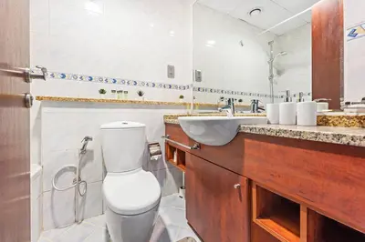 a bathroom with a toilet and a sink at StoneTree - Furnished Studio Near Metro in Dubai