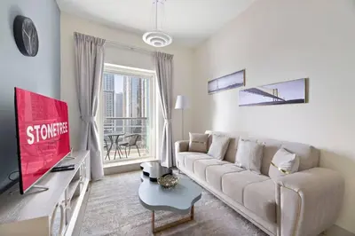 a living room with a couch and a large window at StoneTree - Elegant 1 BR with Amazing View in Dubai