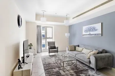 a living room with a couch and a chair at StoneTree - Sea View - High-Floor in Dubai