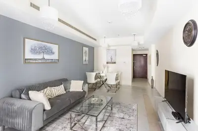 a living room with a couch and a table at StoneTree - Sea View - High-Floor in Dubai