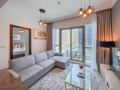 a living room with a couch and a glass table at StoneTree - Furnished 1BR near Marina Walk in Dubai