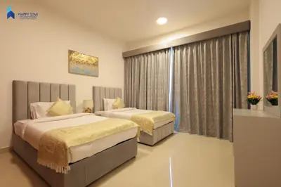 a hotel room with two beds and a window at Stylish 2BR Suite Near MOE in Dubai