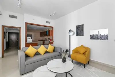 a living room with a couch and a table at StoneTree - Homelike 1BR in Dubai Marina in Dubai