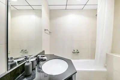 a bathroom with a sink and a tub at StoneTree - Stylish 1BR in JLT in Dubai