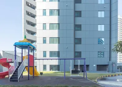 a playground with a slide in front of a building at StoneTree - Cozy Studio Apartment in Business Bay in Dubai