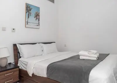 a bedroom with a bed with two towels on it at StoneTree - Cozy Studio Apartment in Business Bay in Dubai