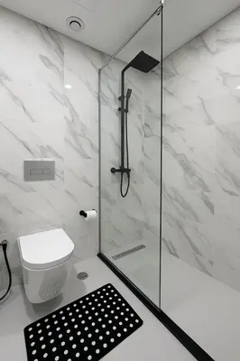 a bathroom with a toilet and a glass shower at Stunning Studio in Dubai in Dubai
