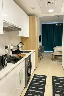 a kitchen with a washing machine and a stove at Stunning Studio in Dubai in Dubai