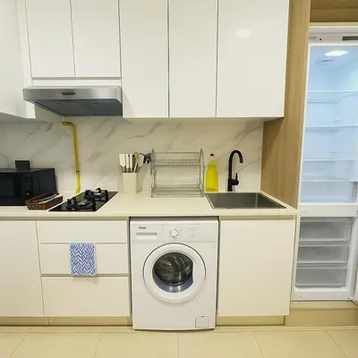 a kitchen with a washing machine and a sink at Stunning Studio in Dubai in Dubai