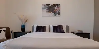a bedroom with a large white bed with pillows at Classy 1 BR Apartment in Greens in Dubai