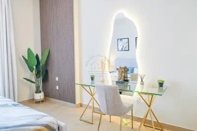 a bedroom with a glass table and a mirror at Yogi - Luxury Apartment With Sea View Close to the Beach in Dubai