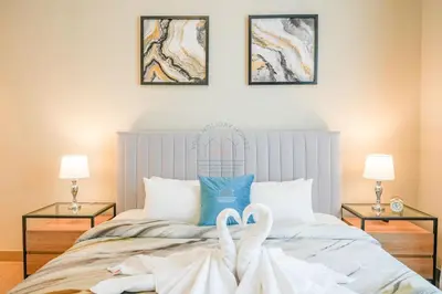 a bedroom with a bed with two towels on it at Yogi - Luxury Apartment With Sea View Close to the Beach in Dubai