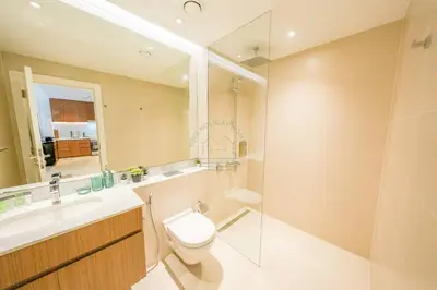 a bathroom with a toilet and a sink and a mirror at Yogi - Luxury Apartment With Sea View Close to the Beach in Dubai