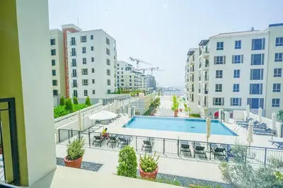 a view of a pool from a balcony of a building at Yogi - Luxury Apartment With Sea View Close to the Beach in Dubai