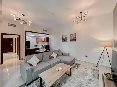 a living room with a couch and a table at StoneTree - Modern 1 BR Apartment Near The Beach in Dubai