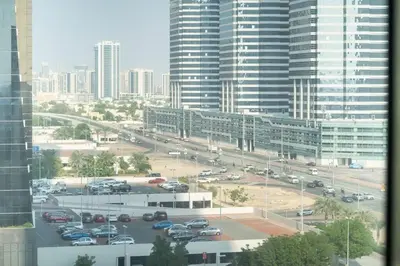 a view of a parking lot in a city with cars at StoneTree - Chic Studio in Jumeirah Lake Towers in Dubai