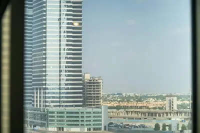 a view of a tall building from a window at StoneTree - Chic Studio in Jumeirah Lake Towers in Dubai