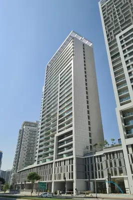 a tall building in a city with two tall buildings at Contemporary 1BR at Vera Tower Business Bay by Deluxe Holiday Homes in Dubai