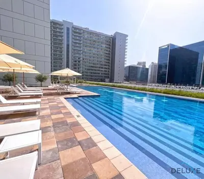 a swimming pool on the roof of a building at Contemporary 1BR at Vera Tower Business Bay by Deluxe Holiday Homes in Dubai