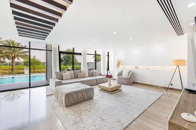 a living room with a couch and a table at Daniels 5BR Villa with Private Pool at Damac Hills in Dubai