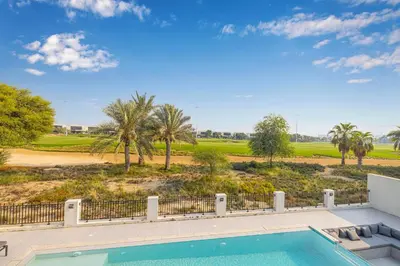a swimming pool with a view of a golf course at Daniels 5BR Villa with Private Pool at Damac Hills in Dubai