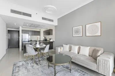 a living room with a couch and a table at StoneTree - Furnished 1 BR in Bay Central in Dubai