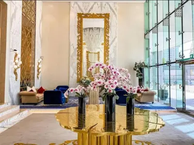 a lobby with a glass table with flowers on it at Phineek Homes Luxury Studio With Canal View Damac Maison Prive Business Bay in Dubai