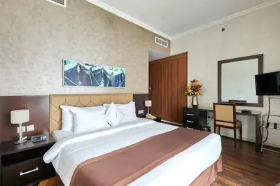 a hotel room with a large bed and a desk at City Premiere Marina Hotel Apartments in Dubai