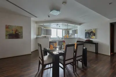 a dining room and kitchen with a table and chairs at City Premiere Marina Hotel Apartments in Dubai