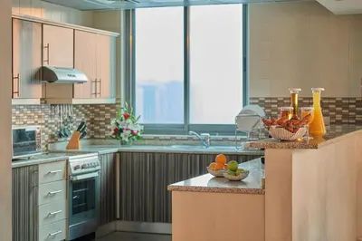 a kitchen with a counter with a bowl of fruit on it at City Premiere Marina Hotel Apartments in Dubai