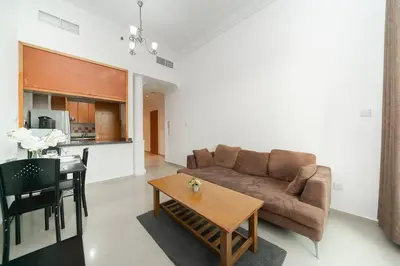 a living room with a couch and a table at StoneTree - Fully Furnished 1BR near Metro Station in Dubai