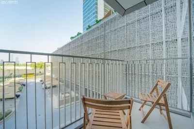 two chairs on a balcony with a view of a city at Downtown Views II Tower 1 brand new units in Dubai