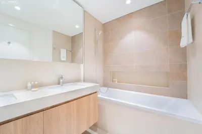 a bathroom with a tub and a sink and a bath tubermottermott at Downtown Views II Tower 1 brand new units in Dubai