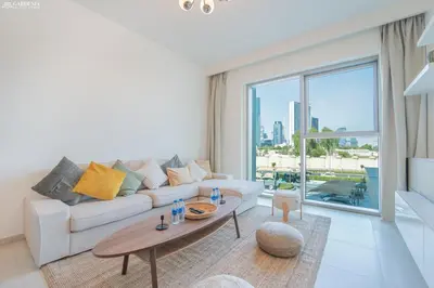 a living room with a couch and a table at Downtown Views II Tower 1 brand new units in Dubai