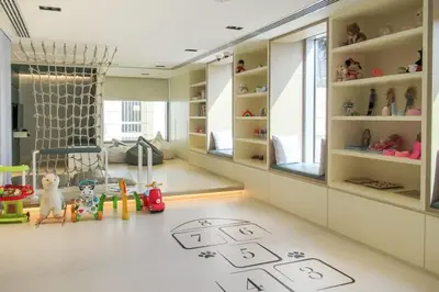 a childs room with a play area with a floor at Frank Porter - Burj Daman in Dubai