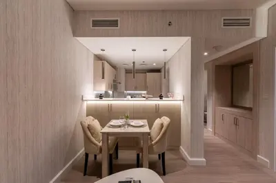 a kitchen and dining room with a table and chairs at Seven Palm, Palm Jumeirah - Mint Stay in Dubai