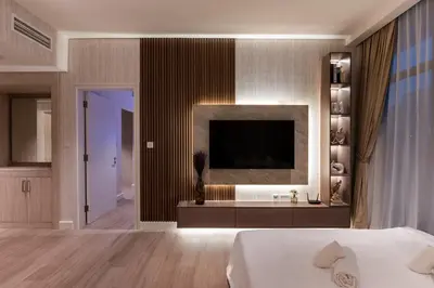 a bedroom with a bed and a television on a wall at Seven Palm, Palm Jumeirah - Mint Stay in Dubai