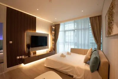 a bedroom with a white bed and a large window at Seven Palm, Palm Jumeirah - Mint Stay in Dubai