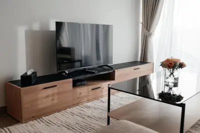 a living room with a television on a dresser at 2BR 1 Residences Zabeel with Sleeps 5 - Luxury Stay in Dubai